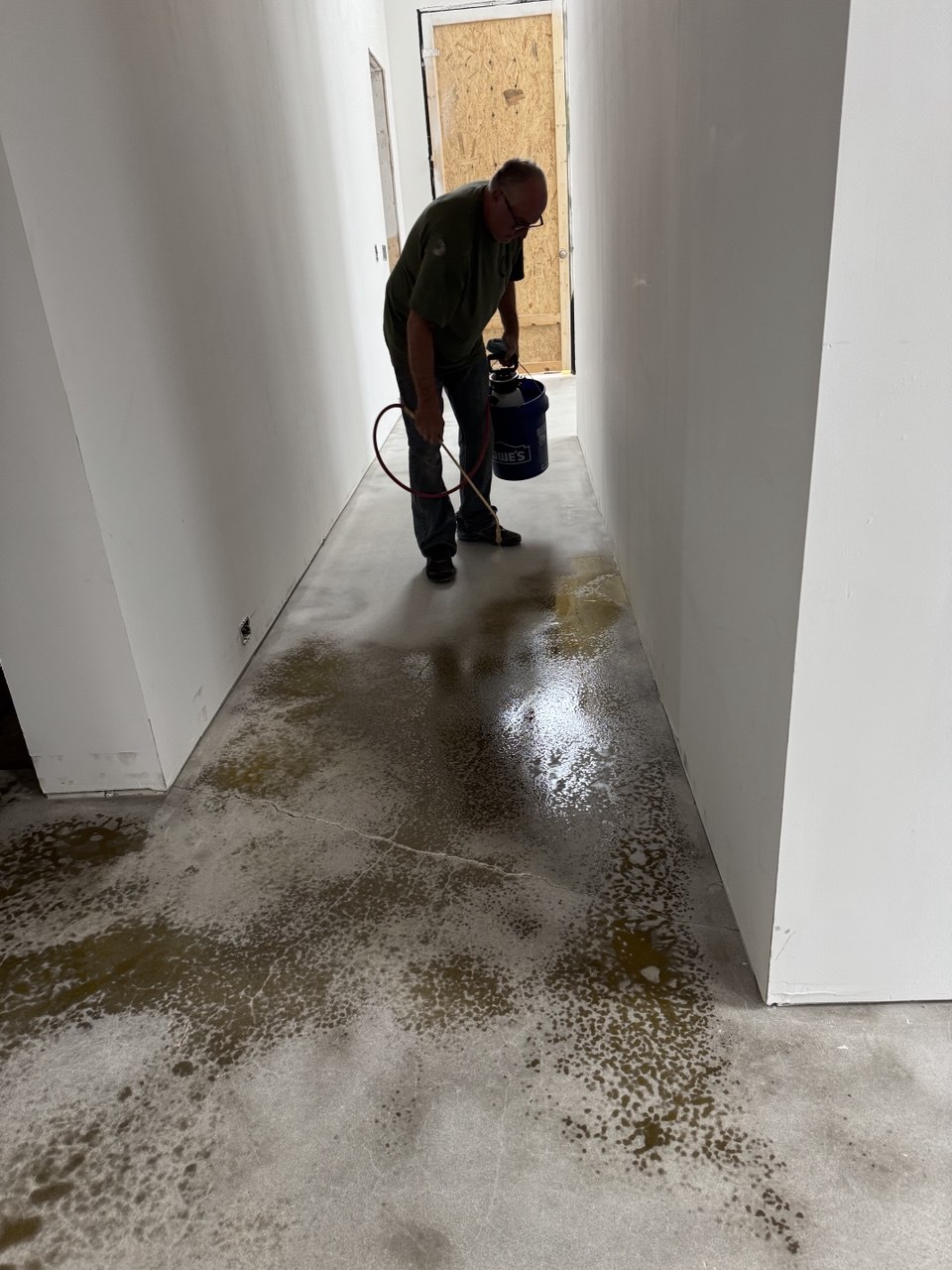 Applying acid stain to concrete floor