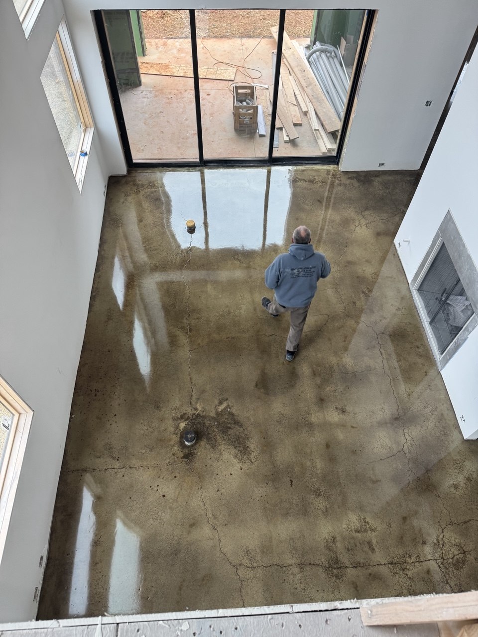 Olive stained concrete floor in open home