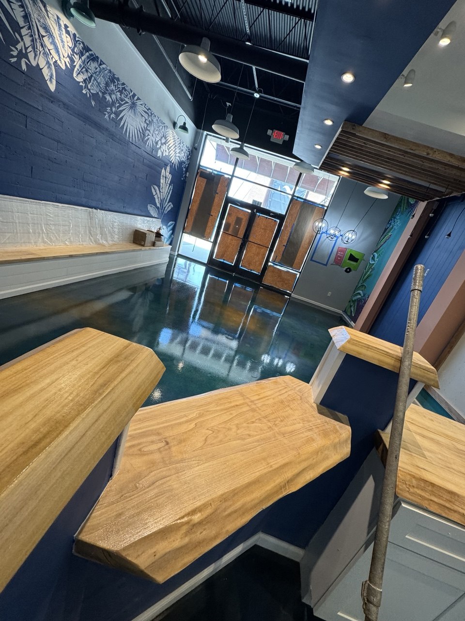 Teal acid-stained concrete floor in boutique